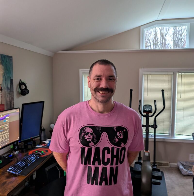 Mike Keister, smiling, in his home office